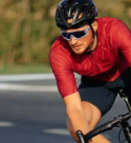 Cyclist wearing men's cycling clothing, one of the clombian road cycling helmets