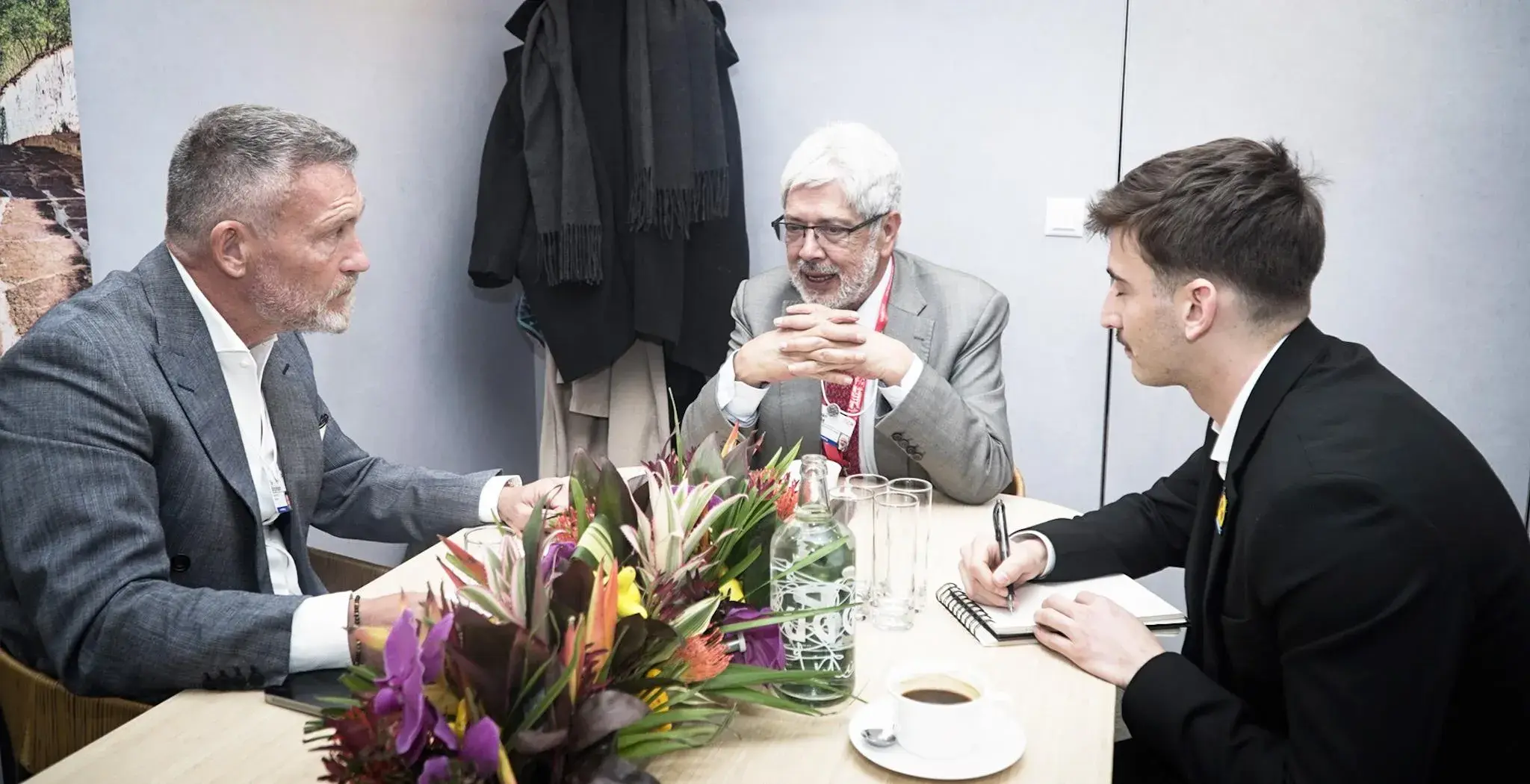 Tres directivos hablando en una mesa