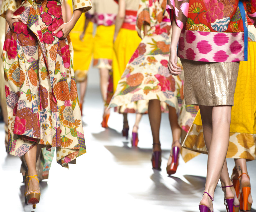 Colombian models on a runway showcasing the diversity in the fashion industry with garments of different colors that show cultural traditions.